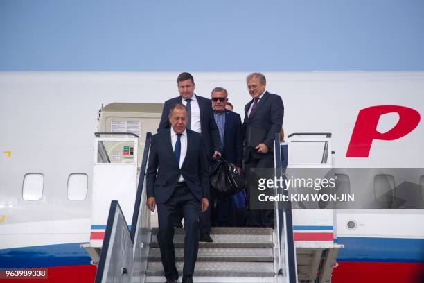 Russia's Foreign Minister Sergei Lavrov walks down the airplane as he arrives in Pyongyang on May 31, 2018. - Russian Foreign Minister Sergei Lavrov...