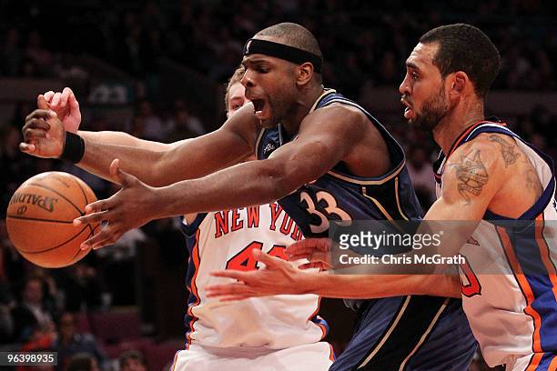Brendan Haywood of the Washington Wizards loses the ball under pressure from David Lee and Jared Jeffries of the New York Knicks at Madison Square...