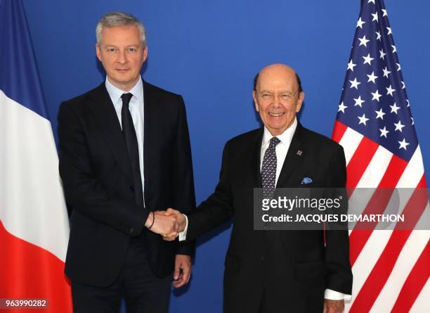 French Economy Minister Bruno Le Maire and US Commerce Secretary Wilbur Ross pose for a photo on May 31, 2018 at the finance ministry in Paris.
