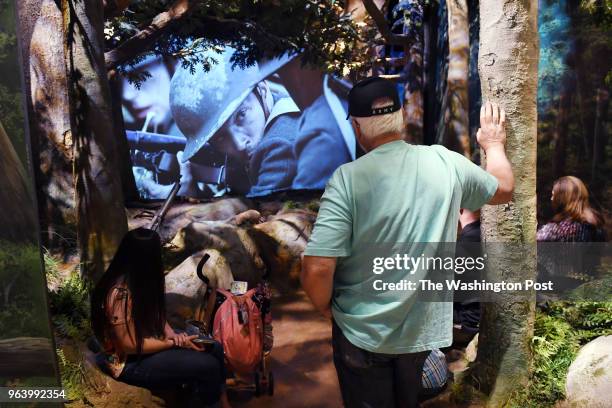 Harlan Greeves of Monroe City, MO watches a short film depicting the Battle of Belleau Wood at the National Museum of the Marine Corps on Tuesday May...