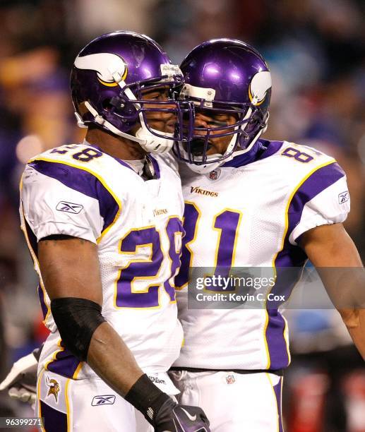 Adrian Peterson and Visanthe Shiancoe of the Minnesota Vikings against the Carolina Panthers at Bank of America Stadium on December 20, 2009 in...