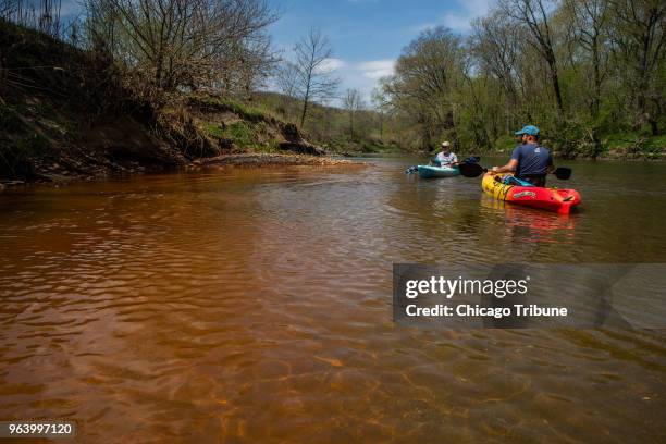 Andrew Rehn, right, of Prairie Rivers Network from Champaign, Ill., and Lan Richart of Eco-Justice Collaborative also from Champaign, paddle past the...