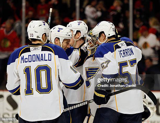 Members of the St. Louis Blues including Andy McDonald and David Perron congratulate goalie Chris Mason after a win over the Chicago Blackhawks at...