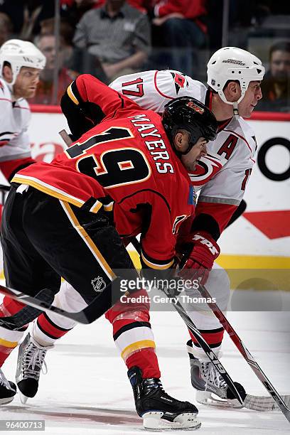 Jamal Meyers of the Calgary Flames faces off against Rod Brind'Amour#17 of the Carolina Hurricanes on February 3, 2010 at Pengrowth Saddledome in...