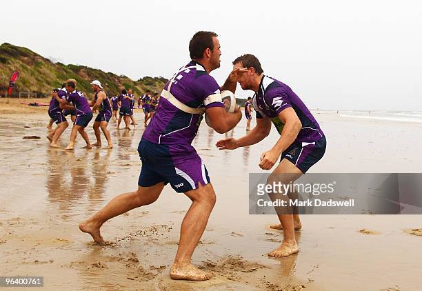 Ryan Tandy and Ryan Hoffman of the Storm complete a tackling drill during a Melbourne Storm NRL training session at Anglesea Beach on February 4,...