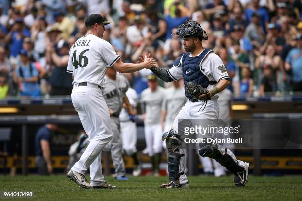 Corey Knebel and Manny Pina of the Milwaukee Brewers celebrate after beating the New York Mets 8-7 at Miller Park on May 27, 2018 in Milwaukee,...