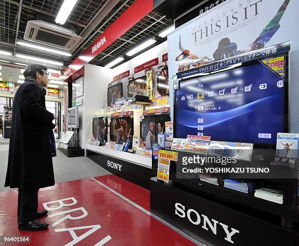Customer looks at Sony LCD TVs at a Tokyo electric shop on February 4, 2010. Japanese consumer electronics giant Sony Corp. Announced an...