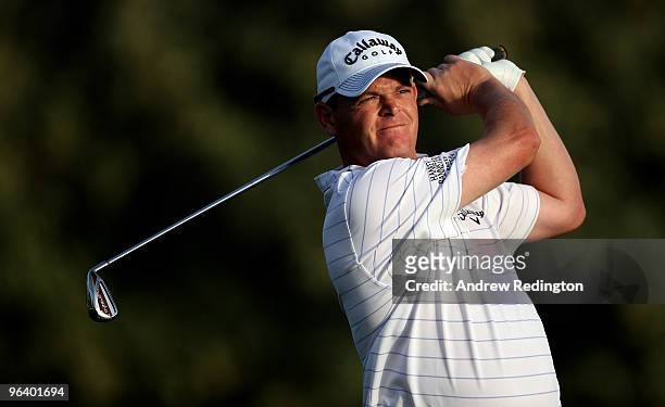 David Drysdale of Scotland hits his second shot on the third hole during the first round of the Omega Dubai Desert Classic on February 4, 2010 in...