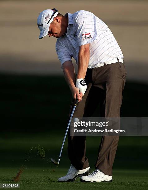 David Drysdale of Scotland hits his third shot on the third hole during the first round of the Omega Dubai Desert Classic on February 4, 2010 in...