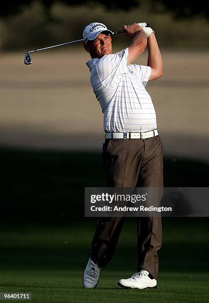 David Drysdale of Scotland hits his third shot on the third hole during the first round of the Omega Dubai Desert Classic on February 4, 2010 in...