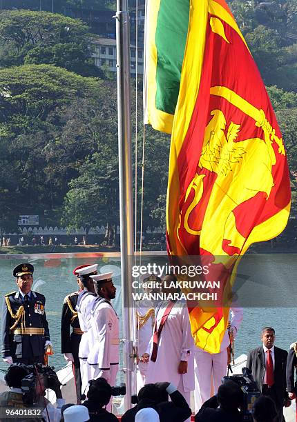 Sri Lankan President Mahinda Rajapakse hoists the national flag during the island's 62th Independence Day celebrations outside the highly venerated...