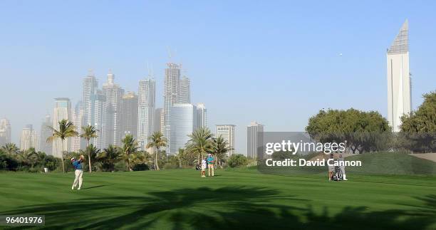 Lee Westwood of England plays his second shot at the par 5, 13th hole during the first round of the 2010 Omega Dubai Desert Classic on the Majilis...