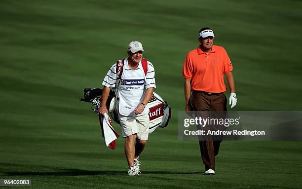 Anthony Wall of England walks with his caddie John Curtis on the third hole during the first round of the Omega Dubai Desert Classic on February 4,...