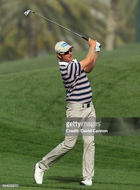 Mikko Illonen of Finland plays his second shot at the par 5, 15th hole during the first round of the 2010 Omega Dubai Desert Classic on the Majilis...
