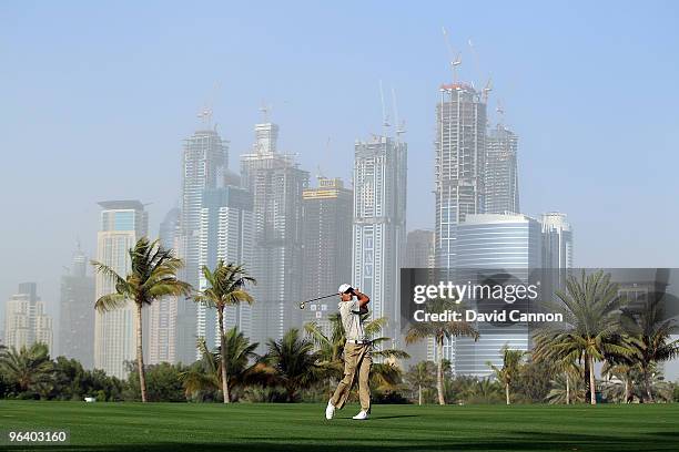 Charl Schwartzel of South Africa plays his second shot at the par 5, 13th hole during the first round of the 2010 Omega Dubai Desert Classic on the...
