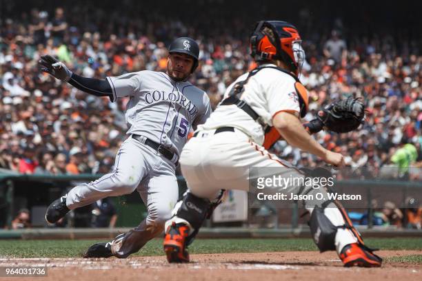 Noel Cuevas of the Colorado Rockies is tagged out at home plate by Nick Hundley of the San Francisco Giants during the fourth inning at AT&T Park on...