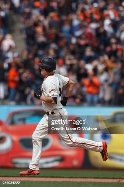 Nick Hundley of the San Francisco Giants rounds the bases after hitting a home run against the Colorado Rockies during the seventh inning at AT&T...