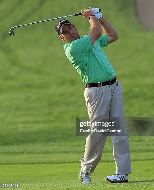 Hennie Otto of South Africa plays his second shot at the 12th hole during the first round of the 2010 Omega Dubai Desert Classic on the Majilis...