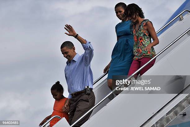 President Barack Obama, First Lady Michelle Obama and their daughters Malia and Sasha disembark from Air Force One upon their arrival at the Hickam...