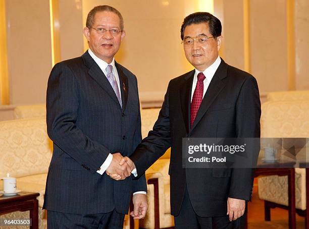 Jamaican Prime Minister Bruce Golding meets with Chinese President Hu Jintao at the Great Hall of the People February 4, 2010 in Beijing, China....