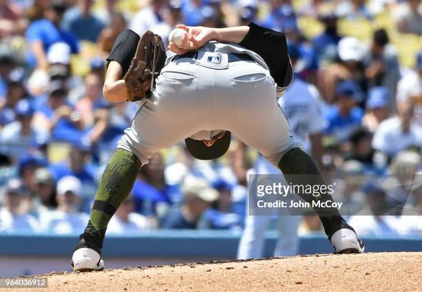 Adam Cimber of the San Diego Padres bows deeply into his wind-up before pitching against the Los Angeles Dodgers in the third inning at Dodger...