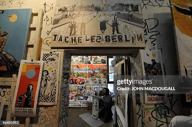 Artist assistant Jake Sweetman mounts prints by Dutch artist Tim Roeloffs in the Kunsthaus Tacheles artists' colony in Berlin's Mitte district...