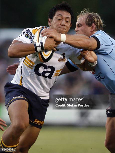 Christian Lealiifano of the Brumbies is tackled by Phil Waugh of the Waratahs during the Super 14 trial match between the Brumbies and the Waratahs...