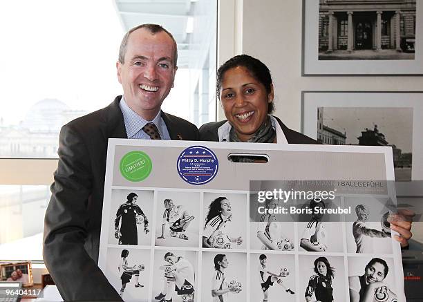 Organizing Committee President Steffi Jones presents US Ambassador Philip D. Murphy a calender of the german female soccer national team during their...