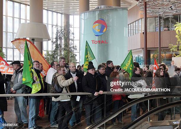 Employees of French oil giant Total storm on February 1, 2010 the tower of Total in La Defense near Paris, to protest against the closure of Dunkirk...