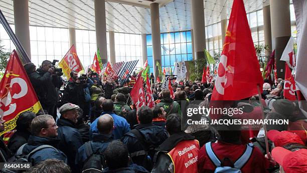 Employees of French oil giant Total storm on February 1, 2010 the tower of Total in La Defense near Paris, to protest against the closure of Dunkirk...