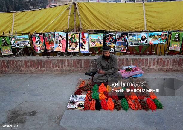 Pakistani man sells posters of Muslim religious characters outside the Data Darbar where is the Saint Syed Ali bin Osman Al-Hajvery shrine, popularly...