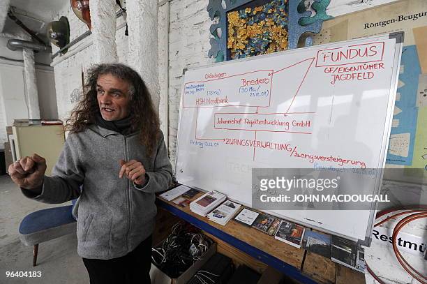 Spokesperson for the artists collective Martin Reiter speaks to a journalist in front of a diagramme explaining their situation in the Kunsthaus...