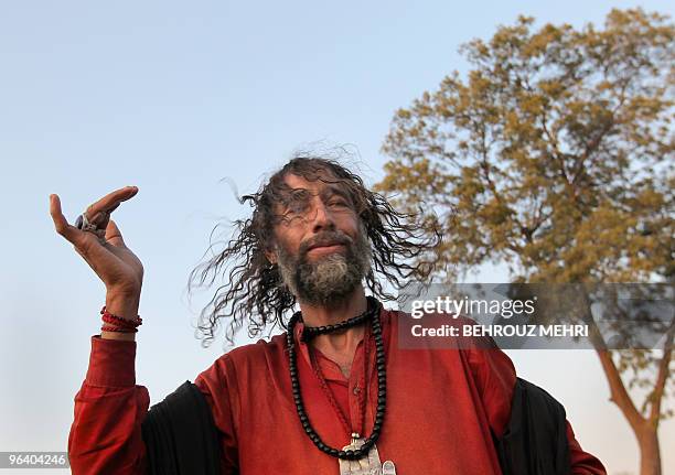 Pakistani Muslim Sufi bangs his head and prays in a Christian grave yard next to the Data Darbar where is the Saint Syed Ali bin Osman Al-Hajvery...