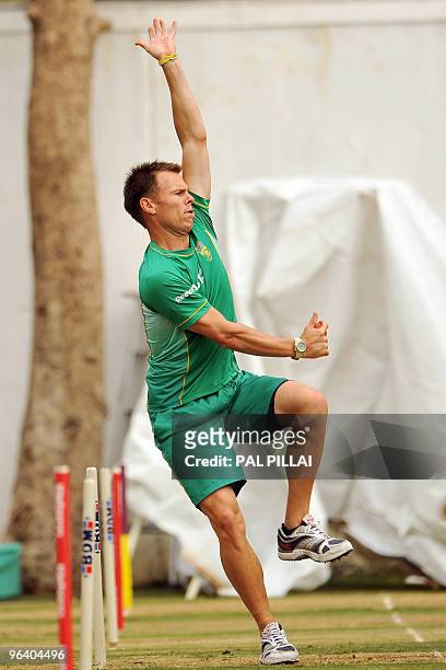 South African cricketer Johan Botha bowls at the net during a practice session in Nagpur on February 4, 2010. The first of the two-match Test series...