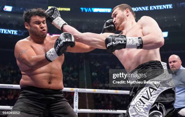 Arsianbek Makhmudov of Canada punches Elder Hernandez of Mexico during their Heavyweight fight at the Videotron Center on May 26, 2018 in Quebec...