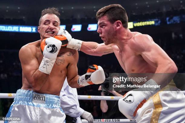 Raphael Courchesne of Canada punches Ivan Banach of Argentina during their Super Welterweight fight at the Videotron Center on May 26, 2018 in Quebec...