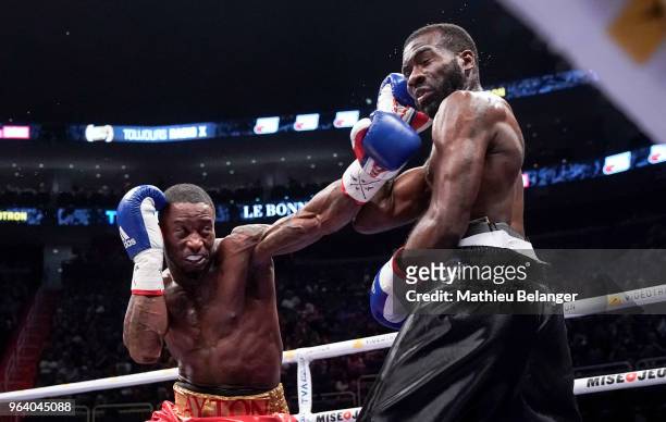 Custio Clayton of Canada punches Stephen Danyo of Great Britain during their welterweight fight at the Videotron Center on May 26, 2018 in Quebec...