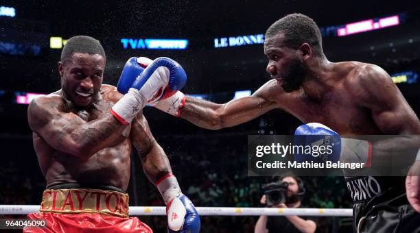 Custio Clayton of Canada punches Stephen Danyo of Great Britain during their welterweight fight at the Videotron Center on May 26, 2018 in Quebec...