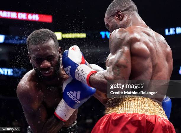 Custio Clayton of Canada punches Stephen Danyo of Great Britain during their welterweight fight at the Videotron Center on May 26, 2018 in Quebec...