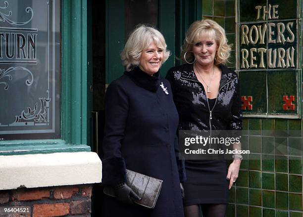 Camilla, Duchess of Cornwall laughs as she chats to cast member Beverley Callard outside the Rovers Return during a tour of the Coronation Street set...