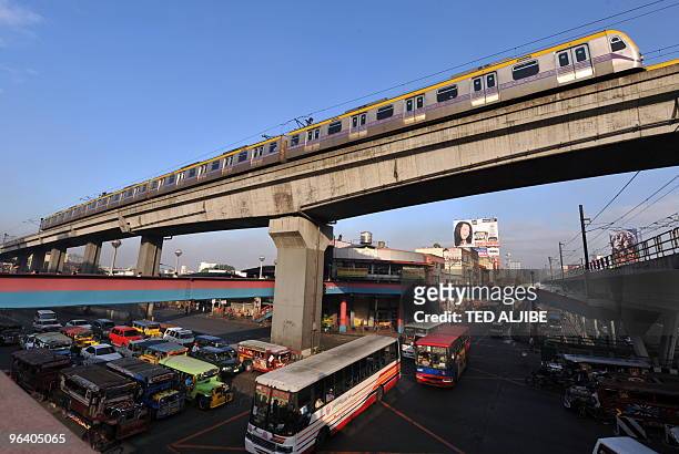Manila Railway Transit train rides over the Santolan and Divisoria route passes in Manila on January 21, 2009. The MRT 3 along with another...