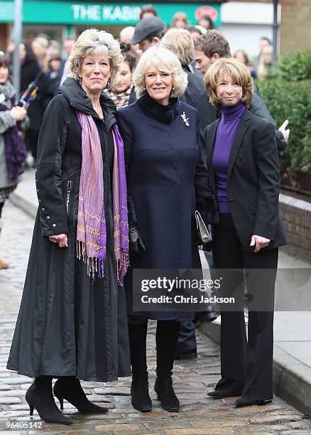 Camilla, Duchess of Cornwall smiles as she chats to cast members Helen Worth and Sue Nicholls during a tour of the Coronation Street set on February...