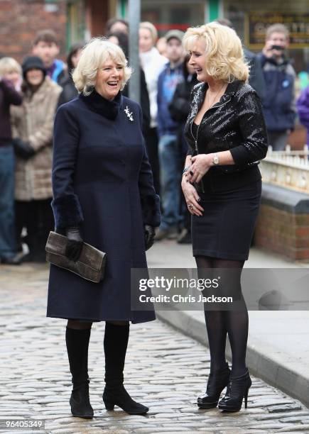 Camilla, Duchess of Cornwall laughs as she chats to cast member Beverley Callard during a tour of the Coronation Street set on February 4, 2010 in...