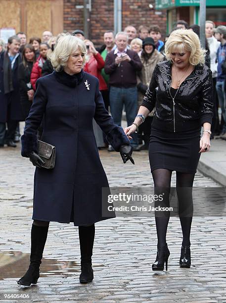Camilla, Duchess of Cornwall laughs as she chats to cast member Beverley Callard during a tour of the Coronation Street set on February 4, 2010 in...