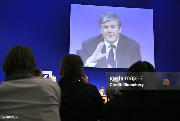 Josef Ackermann, chief executive officer of Deutsche Bank AG, gestures while speaking on a large screen at a news conference in Frankfurt, Germany,...