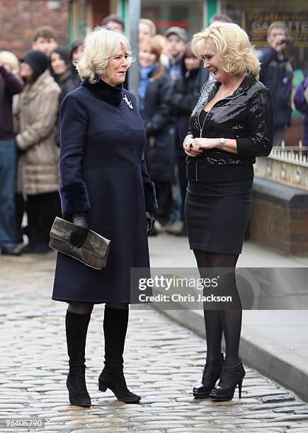 Camilla, Duchess of Cornwall laughs as she chats to cast member Beverley Callard during a tour of the Coronation Street set on February 4, 2010 in...