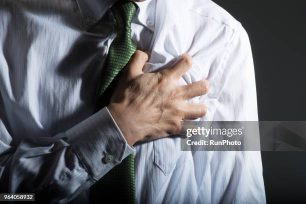 close up of businessman with chest pain - heart disease stock pictures, royalty-free photos & images