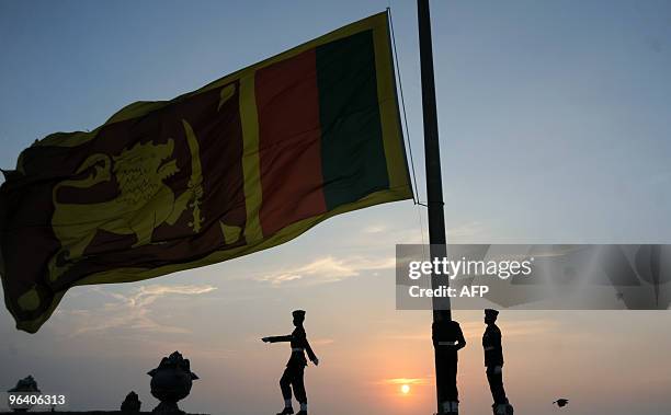 Sri Lankan soldiers lower their national flag in the evening of the nation's 62th Independence Day in Colombo on February 4, 2010. Sri Lankan...