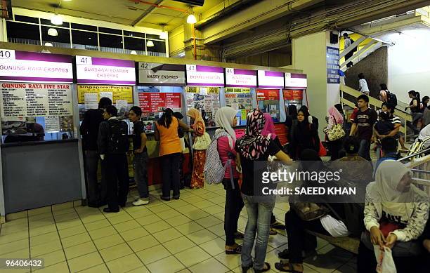 Passengers buy tickets at the waiting lounge at Pudu Bus terminal in Kuala Lumpur on January 29, 2010. AFP PHOTO/Saeed KHAN
