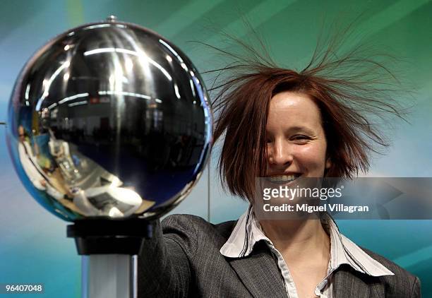 Woman's hair stands up as she touches an Van de Graaff generator during the International Toy Fair on February 4, 2010 in Nuremberg, Germany. 2,700...